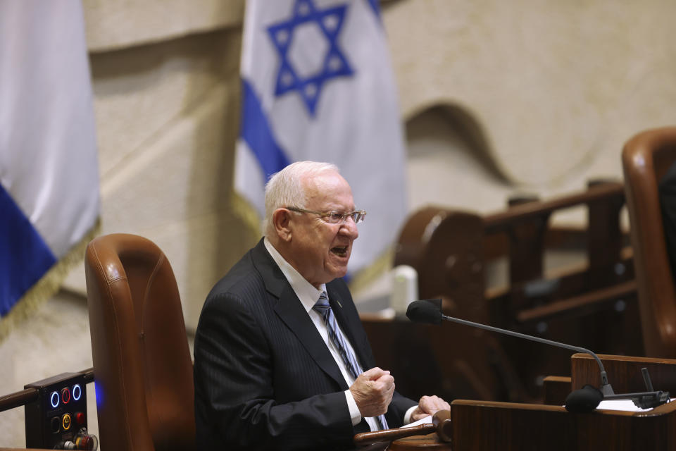 Israeli President Reuvan Rivlin speaks during the swearing-in ceremony for Israel's 24th government, at the Knesset, or parliament, in Jerusalem, Tuesday, April 6, 2021. The ceremony took place shortly after the country's president asked Prime Minister Benjamin Netanyahu to form a new majority coalition, a difficult task given the deep divisions in the fragmented parliament. (Alex Kolomoisky/Pool via AP)