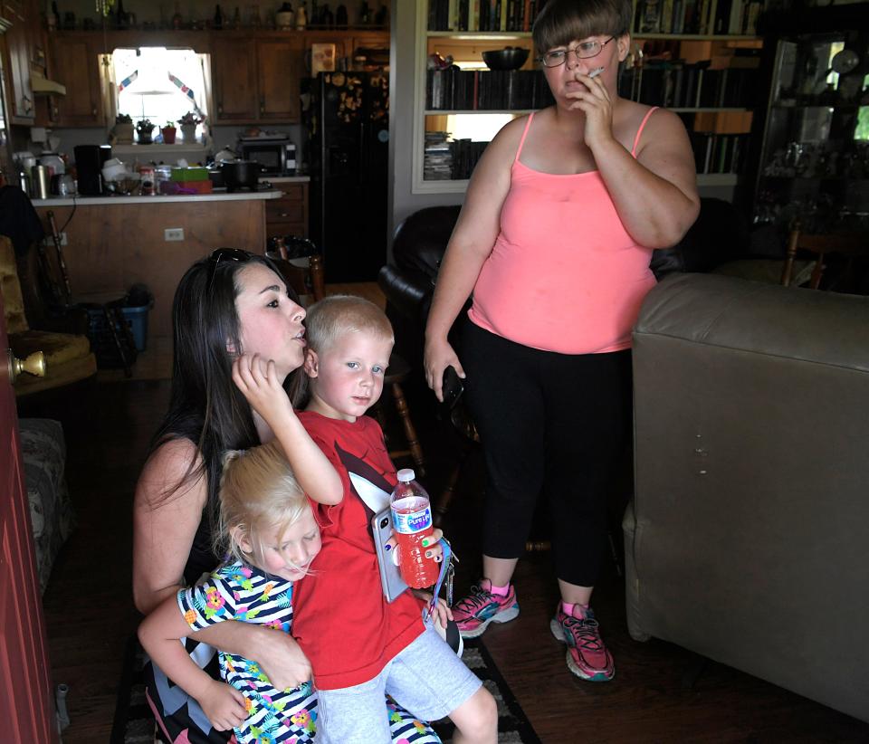 Lacey Lewis, a family intervention specialist with Youth Villages, says goodbye to Bryson Hines, 5, and Addyson Burrage-Gregory, 3, after a visit to their home near Cookeville, Tenn., on Thursday, July 19, 2018. Tasha Burrage, right, and her children are part of a pilot program between Youth Villages and the Department of Children's Services to help children avoid foster care.