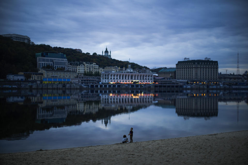 Children play at the Dnipro riverbank in Kyiv, Ukraine, Saturday, Oct. 1, 2022. (AP Photo/Francisco Seco)