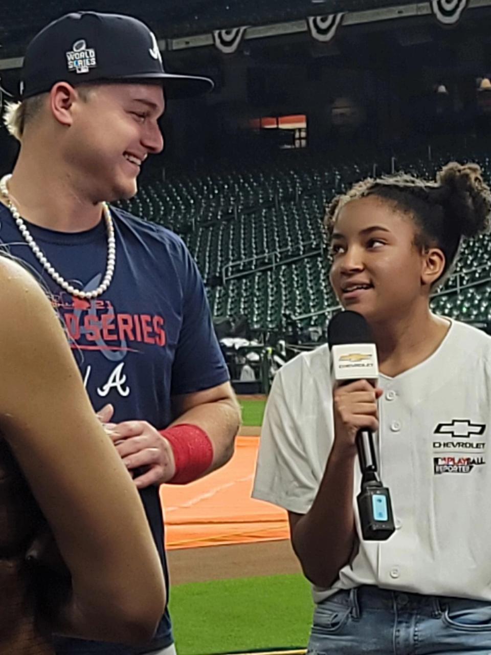 Zora Malone, right, interviews Atlanta Braves outfielder Joc Pederson before Game 1 of the MLB World Series in Houston in October.