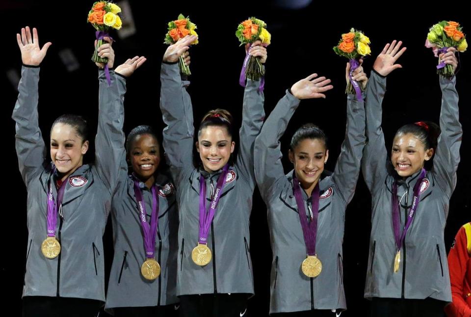 FILE - In this July 31, 2012, file photo, U.S. gymnasts, left to right, Jordyn Wieber, Gabrielle Douglas, McKayla Maroney, Alexandra Raisman and Kyla Ross raise their hands on the podium during the medal ceremony for the Artistic Gymnastic women’s team final at the 2012 Summer Olympics in London.