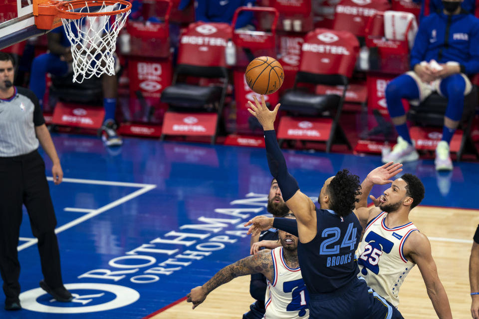 Memphis Grizzlies' Dillon Brooks shoots against Philadelphia 76ers' Mike Scott, left, and Ben Simmons, right, during the first half of an NBA basketball game, Sunday, April 4, 2021, in Philadelphia. The Grizzlies won 116-100. (AP Photo/Chris Szagola)