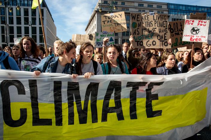 Protesters march through Brussels with placards as they take part in a Global Climate Strike demonstration on Sept. 20, 2019, in Brussels, Belgium.