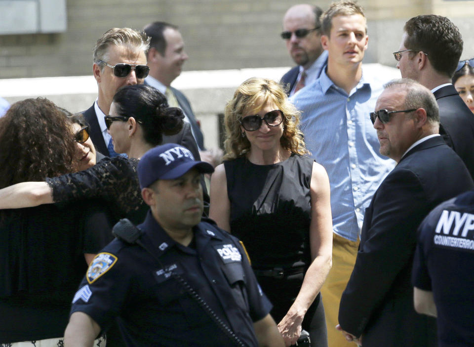 Actress Edie Falco, center, stands outside of Cathedral Church of Saint John the Divine after funeral services actor James Gandolfini, Thursday, June 27, 2013, in New York. Gandolfini, who played Tony Soprano in the HBO show 