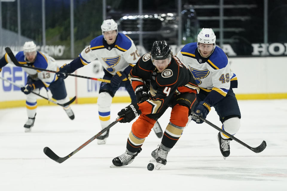 Anaheim Ducks defenseman Cam Fowler (4) and St. Louis Blues center Ivan Barbashev (49) skate to the puck during the first period of an NHL hockey game Sunday, Jan. 31, 2021, in Anaheim, Calif. (AP Photo/Ashley Landis)