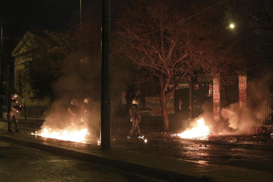 Riot policemen operate during clashes outside the Polytechnic University in Athens, Saturday, Nov. 17, 2018. Greek police say clashes have broken out between police and anarchists in Athens and Thessaloniki on the 45th anniversary of a student uprising against Greece's then-ruling military regime. (AP Photo/Yorgos Karahalis)