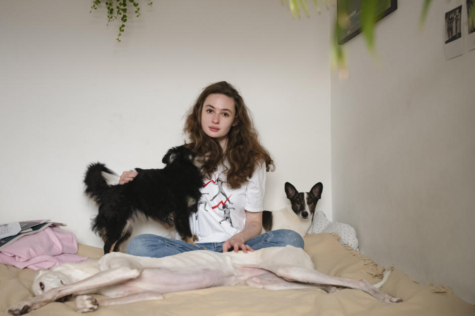 Nina Michnik, a Polish student of Arabic studies and philosophy poses for a portrait together with her dogs in Warsaw, Poland, Saturday, Nov. 21, 2020. The rage of Polish women, and many men as well, erupted onto the streets across the country, growing into the largest protest movement in the three decades since communism fell. (AP Photo/Agata Grzybowska)