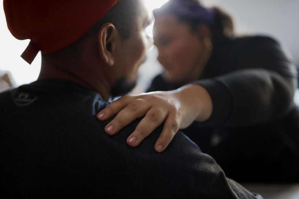 In this Dec. 14, 2019, photo, Dr. Psyche Calderon works with a patient in a shelter for migrants in Tijuana, Mexico. Calderon is a general practitioner volunteering her time to provide care for Central Americans stuck in Mexico while they try to obtain asylum in the United States. (AP Photo/Gregory Bull)