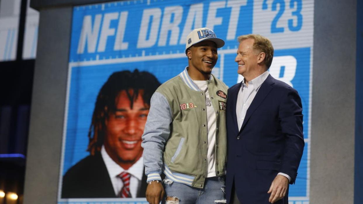 <div>KANSAS CITY, MO - APRIL 28: NFL Commissioner Roger Goodell speaks with Brian Branch, selected by the Detroit Lions in the second round of the 2023 NFL Draft at Union Station on April 28, 2023 in Kansas City, Missouri. (Photo by David Eulitt/Getty Images)</div>