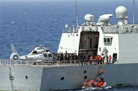 Sailors from the guided-missile destroyer USS Winston S. Churchill board the Chinese People's Liberation Army (Navy) frigate Yi Yang to meet prior to conducting a bilateral counter-piracy exercise in the Gulf of Aden, in this September 17, 2012 handout photo. Navy/Mass Communication Specialist 2nd Class Aaron Chase/Handout/Files