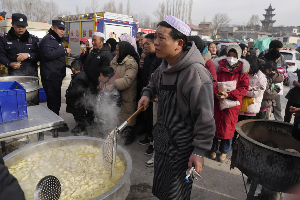 A man prepares dumplings at a temporary shelter for residents after an earthquake in Dahejia town in northwestern China's Gansu province, Wednesday, Dec. 20, 2023. A strong overnight earthquake rattled a mountainous region of northwestern China, authorities said Tuesday, destroying homes, leaving residents out in a below-freezing winter night and killing many in the nation's deadliest quake in nine years. (AP Photo/Ng Han Guan)