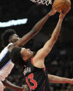 Toronto Raptors forward Jordan Nwora (13) drives to the basket under pressure from Orlando Magic forward Jonathan Isaac (1) during the first half of an NBA basketball game Friday, March 15, 2024, in Toronto. (Frank Gunn/The Canadian Press via AP)