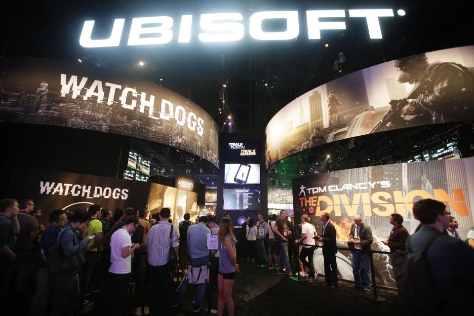 This June 12, 2013 photo shows attendees waiting in line for the presentations on the video games, "Watch Dogs" and "Tom Clancy's The Division" at the Ubisoft booth during the Electronic Entertainment Expo in Los Angeles. Ubisoft's "Watch Dogs" is about a super-hacker who can eavesdrop on phone conversations. It is among several games being hyped at the Electronic Entertainment Expo featuring ripped-from-the-headlines realness. (AP Photo/Jae C. Hong)