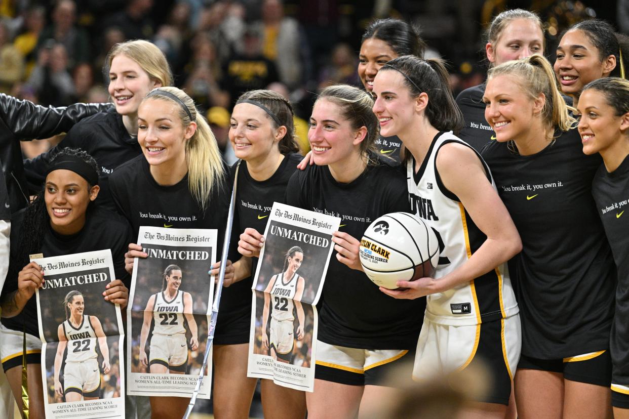 Caitlin Clark celebrates with her Iowa teammates after breaking the NCAA women's college basketball all-time scoring record on Thursday.