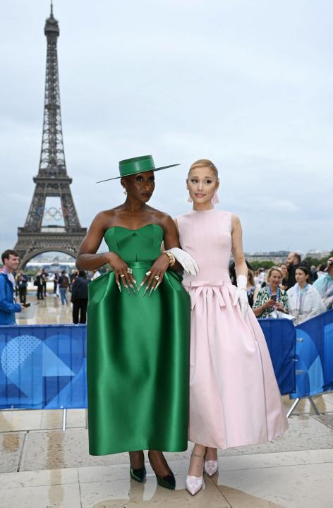 British actress and singer Cynthia Erivo (L) and US' singer Ariana Grande (R) arrive ahead of the opening ceremony of the Paris 2024 Olympic Games in Paris on July 26, 2024, as the Eiffel Tower is seen in the background. (Photo by Jonathan NACKSTRAND / AFP) (Photo by JONATHAN NACKSTRAND/AFP via Getty Images)