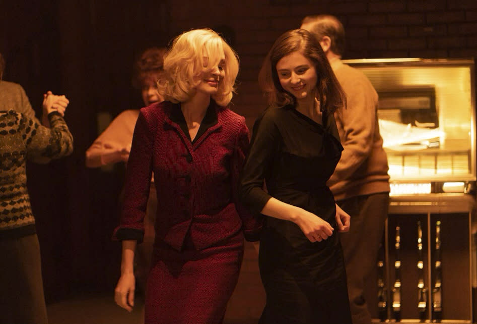 This image released by the Sundance Institute shows Anne Hathaway, left, and Thomasin McKenzie in a scene from "Eileen," which will be featured at the 2023 Sundance Film Festival. (Courtesy of Sundance Institute via AP)