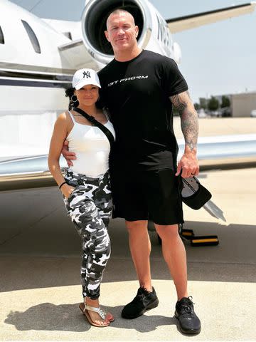 <p>Kim Marie Kessler Instagram</p> WWE star Randy Orton and his wife, Kimberly Marie Kessler, pose next to a plane.