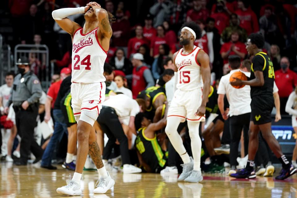 Cincinnati Bearcats guard Jeremiah Davenport (24) and forward John Newman III (15) walk off the court after losing to a game-winning shot as time expired in the second half of a men's NCAA basketball game against the South Florida Bulls, Saturday, Feb. 26, 2022, at Fifth Third Arena in Cincinnati. The South Florida Bulls won, 54-52.