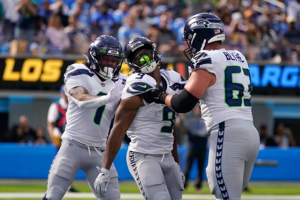 Seattle Seahawks running back Kenneth Walker III (9) celebrates with wide receiver Dee Eskridge (1) guard Austin Blythe (63) after scoring a touchdown during the first half of an NFL football game against the Los Angeles Chargers Sunday, Oct. 23, 2022, in Inglewood, Calif. (AP Photo/Marcio Jose Sanchez)