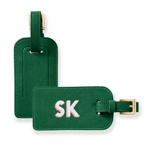 two green luggage tags by mark & graham against white background