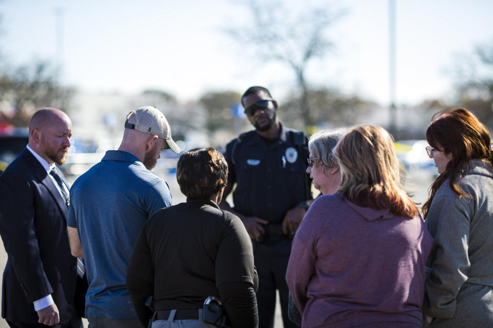 Family members of some of the victims talk with law enforcement in parking lot of Walmart Supercenter, Wednesday, Nov. 23, 2022, in Chesapeake, Va. Andre Bing, a Walmart manager, opened fire on fellow employees in the break room of the Virginia store, killing six people in the country’s second high-profile mass shooting in four days, police and witnesses said Wednesday. (AP Photo/John C. Clark)