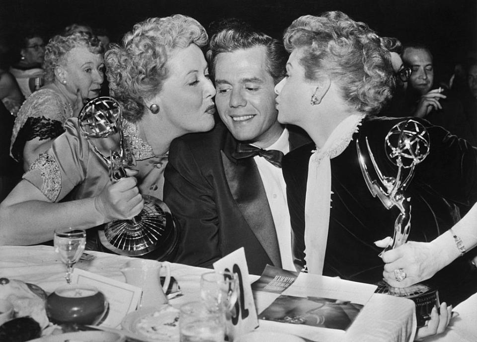 <p>Stars Vivian Vance and Lucille Ball both kiss Desi Arnaz as they celebrate the success of <em>I Love Lucy. </em>Vance took home the Emmy for Best Supporting Actress in 1954, while the show won Best Situation Comedy.</p>