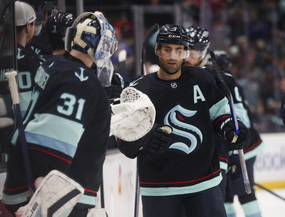 Seattle Kraken right wing Jordan Eberle (7) is greeted by goaltender Philipp Grubauer (31) after scoring against the Detroit Red Wings during the first period of an NHL hockey game Saturday, Feb. 18, 2023, in Seattle. (AP Photo/Lindsey Wasson)
