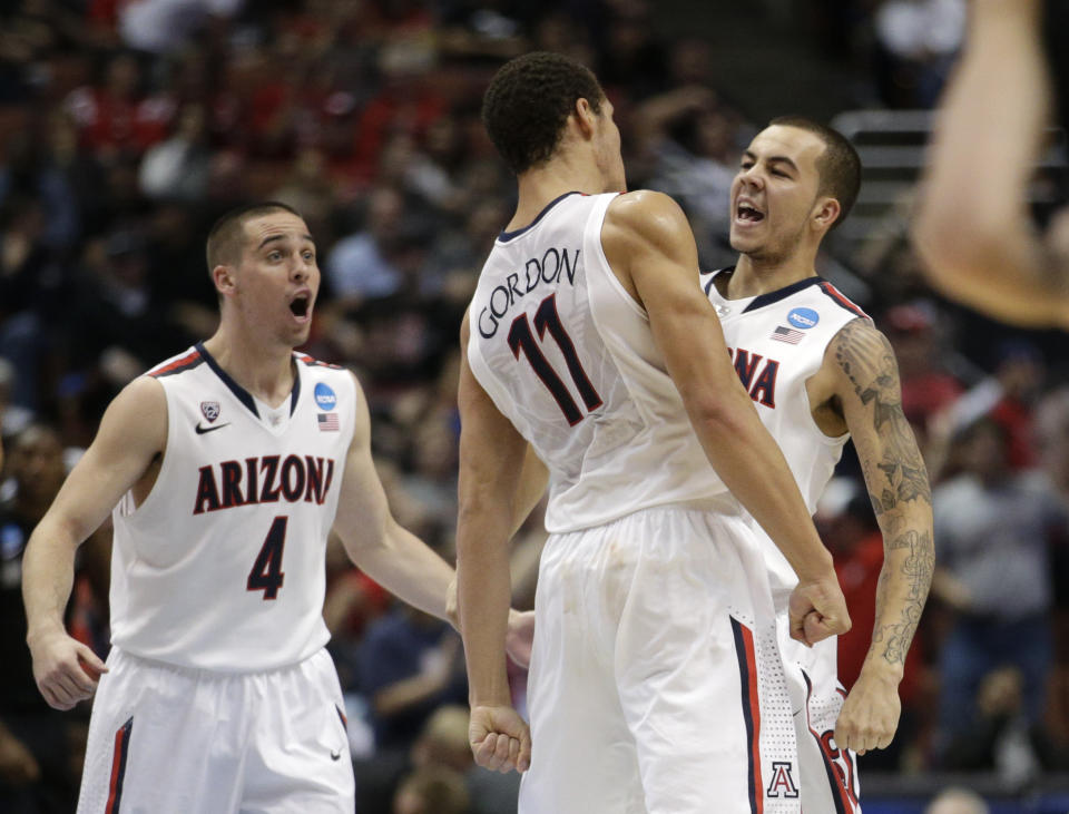 Arizona guard Gabe York, right, celebrates with T.J. McConnell (4) and Aaron Gordon (11) during the second half against San Diego State in a regional semifinal of the NCAA men's college basketball tournament, Thursday, March 27, 2014, in Anaheim, Calif. (AP Photo/Jae C. Hong)