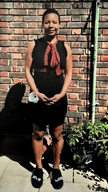 Naomi Hunte standing in front of a wall holding her arms in front of her