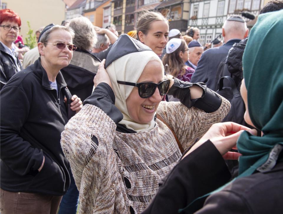 A Muslim woman wears the Kippah during a demonstration against antisemitism: AP
