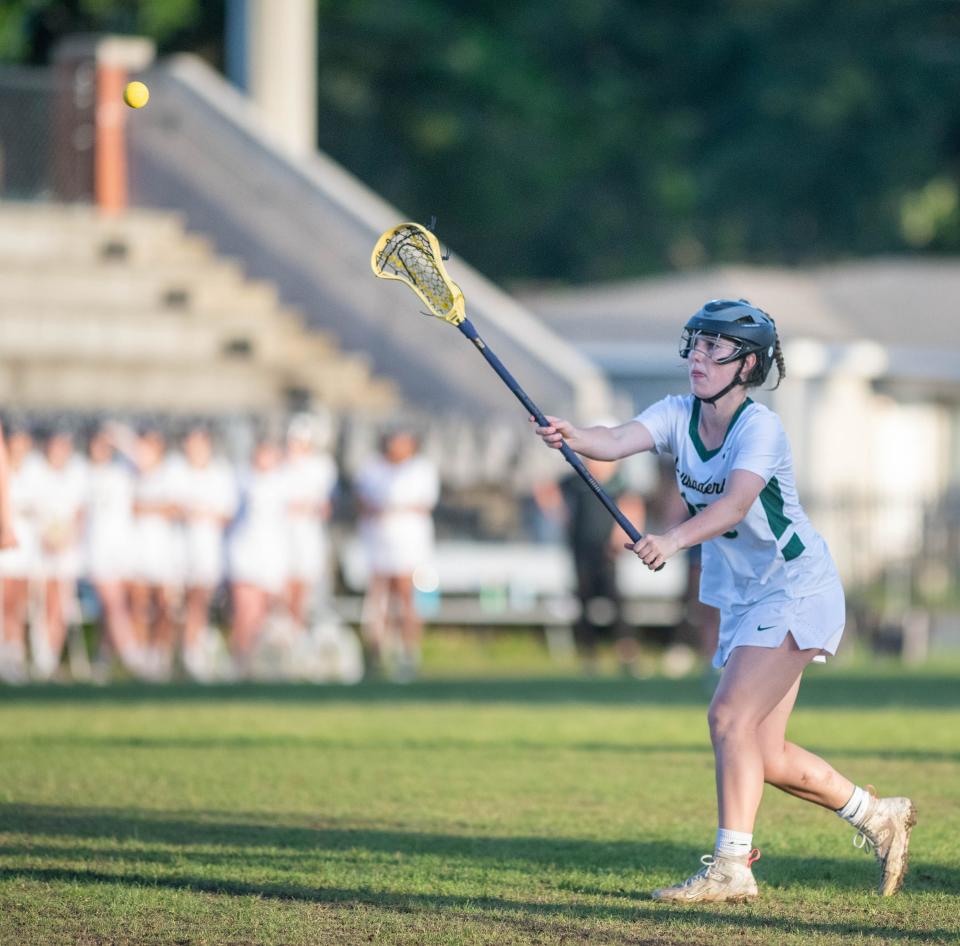 Julia Frosch (12) passes the ball during the South Walton vs Catholic girls District 1-1A championship lacrosse game at Pensacola Catholic High School on Thursday, April 13, 2023.