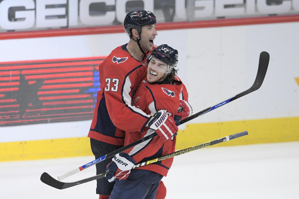 Washington Capitals defenseman Zdeno Chara (33) and right wing T.J. Oshie (77) celebrate after an NHL hockey game against the New York Rangers, Sunday, March 28, 2021, in Washington. The Capitals won 5-4. (AP Photo/Nick Wass)