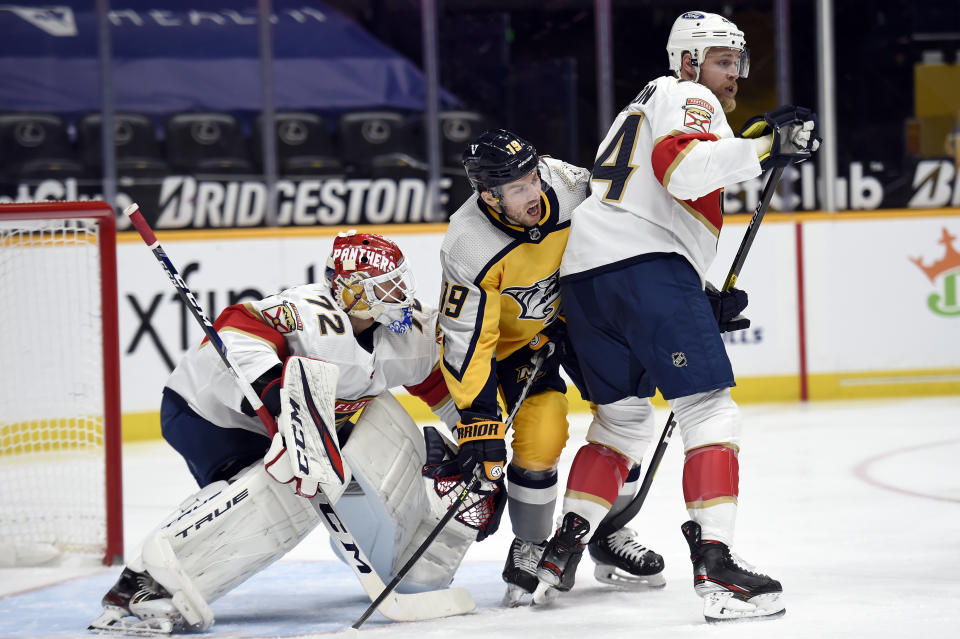 Nashville Predators center Calle Jarnkrok (19) fights to get position between Florida Panthers goaltender Sergei Bobrovsky (72) and defenseman Kevin Connauton (44) during the second period of an NHL hockey game Saturday, March 6, 2021, in Nashville, Tenn. (AP Photo/Mark Zaleski)