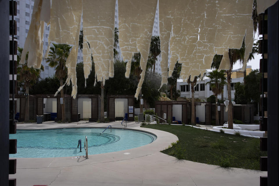A tattered fabric hands from a cabana at the shuttered pool area in the Tropicana hotel-casino Friday, March 29, 2024, in Las Vegas. The casino, which is closing April 2, will be demolished to make room for a proposed baseball stadium. (AP Photo/John Locher)