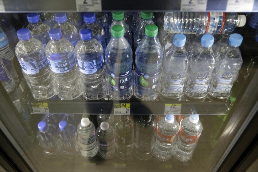 Plastic bottles of water are seen for sale at a store Friday, Aug. 2, 2019, in San Francisco. San Francisco International Airport is banning the sale of single-use plastic water bottles. The unprecedented move at one of the major airports in the country will take effect Aug. 20, the San Francisco Chronicle reported Friday. The new rule will apply to airport restaurants, cafes and vending machines. Travelers who need plain water will have to buy refillable aluminum or glass bottles if they don't bring their own. (AP Photo/Eric Risberg)