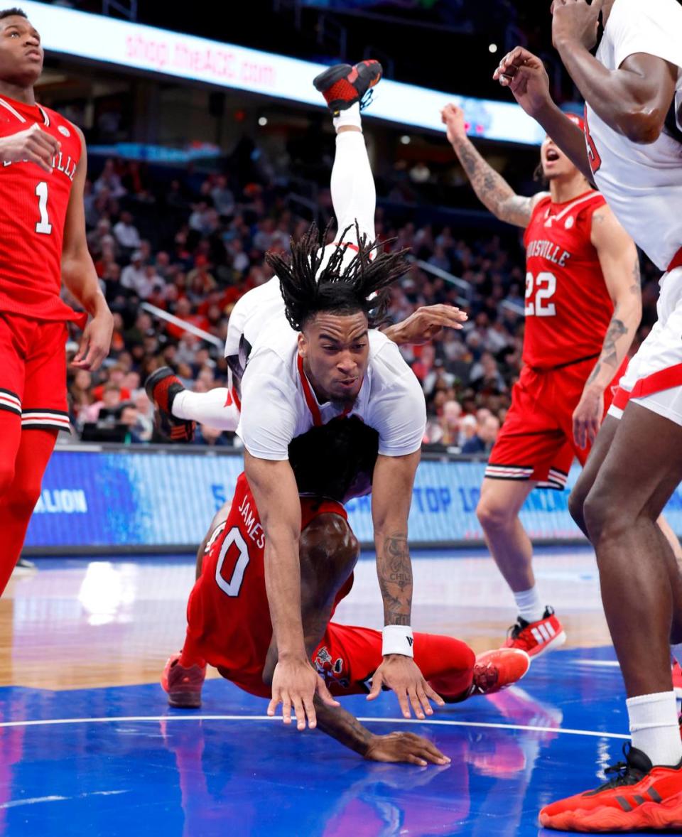N.C. State’s Jayden Taylor (1) goes over Louisville’s Mike James (0) after he was fouled by James during the first half of N.C. State’s game against Louisville in the first round of the 2024 ACC Men’s Basketball Tournament at Capital One Arena in Washington, D.C., Tuesday, March 12, 2024.