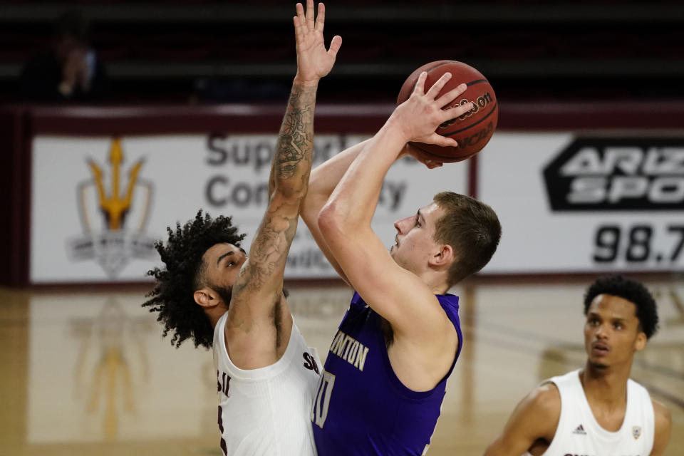 Washington guard Erik Stevenson (10) shoots over Arizona State guard Holland Woods during the second half of an NCAA college basketball game, Thursday, Feb. 25, 2021, in Tempe, Ariz. (AP Photo/Rick Scuteri)