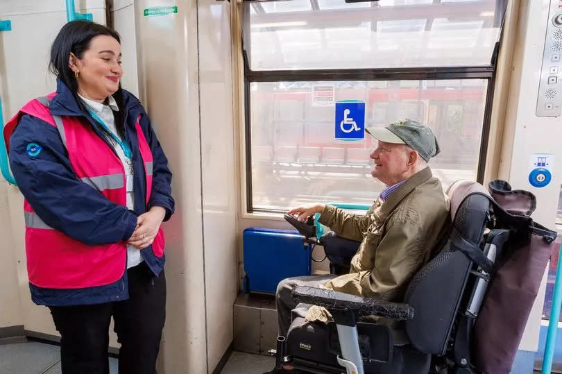 A DLR staff member and a man in a wheelchair