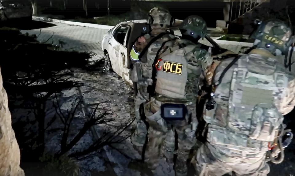In this photo taken from video released by the National Antiterrorism Committee on Monday, June 24, 2024, FSB officers conduct a counter-terrorist operation in the Republic of Dagestan, Russia. Multiple police officers and several civilians, including an Orthodox priest, were killed by armed militants in Russia's southern republic of Dagestan on Sunday, its governor Sergei Melikov said in a video statement early Monday. (The National Antiterrorism Committee via AP)