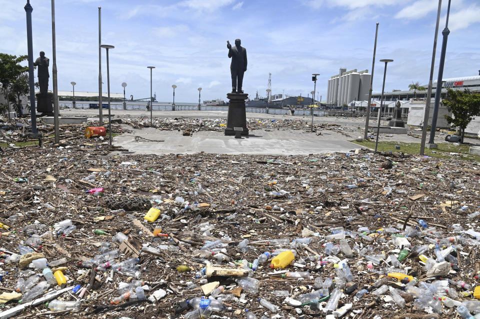 Debris washed up during the cyclone is strewn across the Caudan Waterfront in Port Louis, the capital city of Mauritius, Tueday Jan. 16, 2024. Mauritius lifted its highest weather alert and eased a nationwide curfew Tuesday after a cyclone battered the Indian Ocean island, causing heavy flooding and extensive damage in the capital city and other parts of the country. (Lexpress.mu via AP)