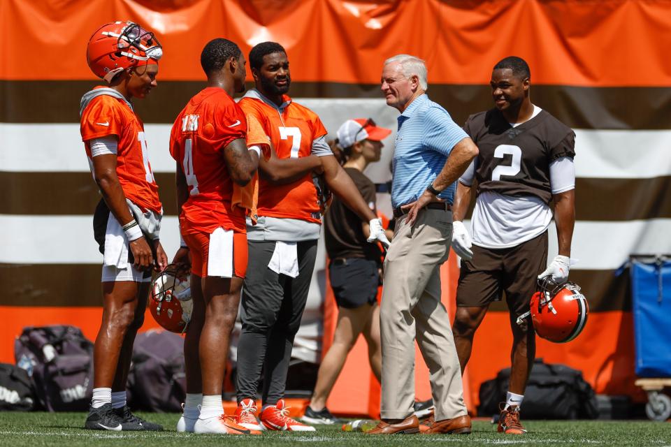 Cleveland Browns managing and principle partner Jimmy Haslam talks with quarterbacks Joshua Dobbs (15), Deshaun Watson (4), Jacoby Brissett (7) and wide receiver Amari Cooper (2) takes part in drills during an NFL football practice at FirstEnergy Stadium, Thursday, June 16, 2022, in Cleveland. (AP Photo/Ron Schwane)