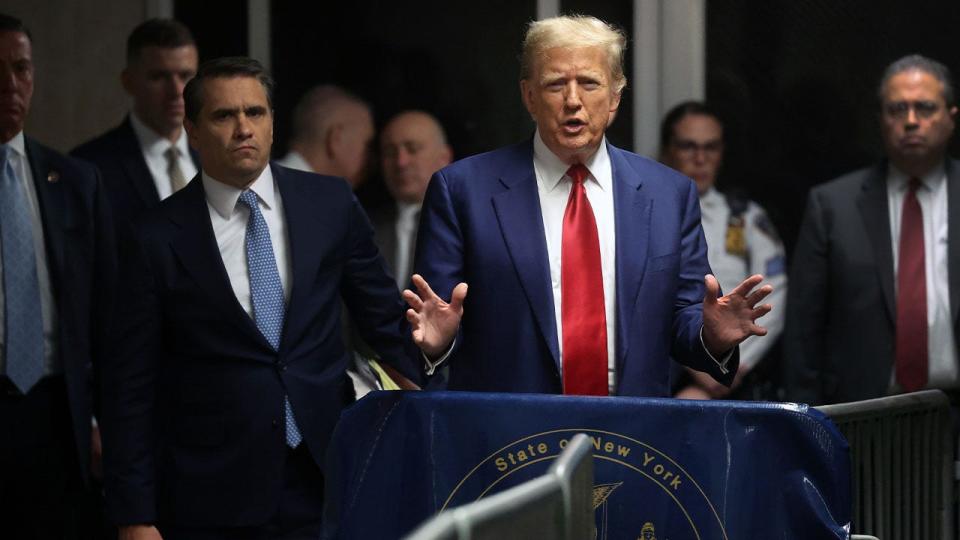 Former President Donald Trump speaks to members of the media in the hallway outside a courtroom at Manhattan criminal court in New York City last month.