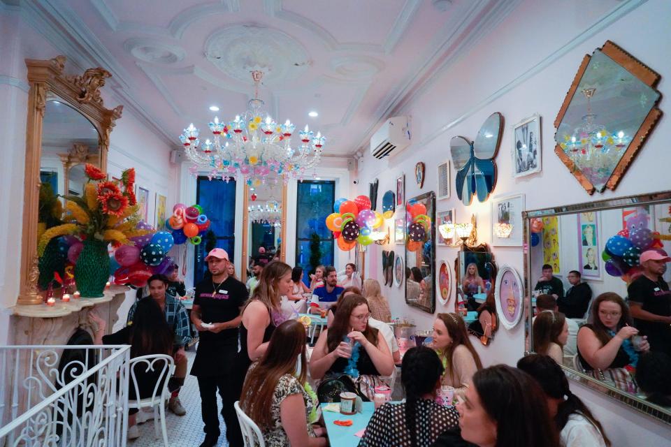 Inside a packed Serendipity 3 restaurant with colorful walls and decor.