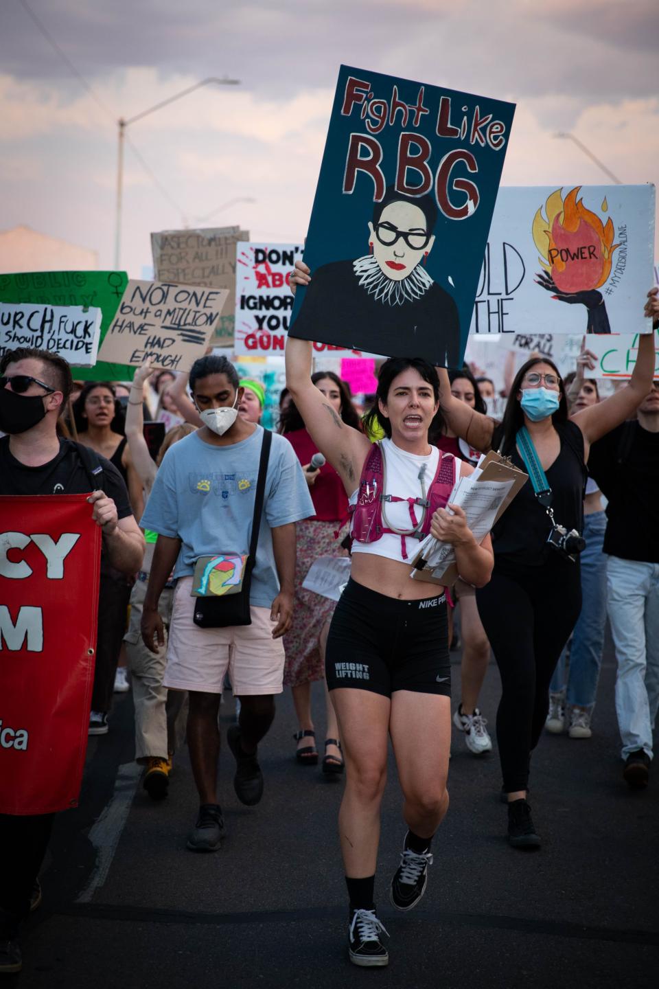 Gabriella Smedes, holding a sign that says, "Fight Like RBG," marches with abortion rights activists during a protest near the Arizona Capitol in Phoenix on July 1, 2022.