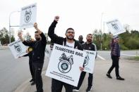 Striking Teamsters union workers picket in Surrey