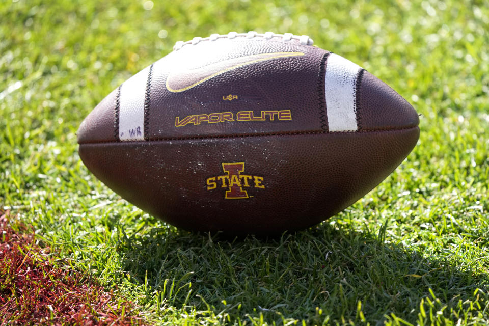 An Iowa State football sits on the field before an NCAA college football game against West Virginia, Saturday, Nov. 5, 2022, in Ames, Iowa. College athletic programs of all sizes are reacting to inflation the same way as everyone else. They're looking for ways to save. Travel and food are the primary areas with increased costs. (AP Photo/Charlie Neibergall)