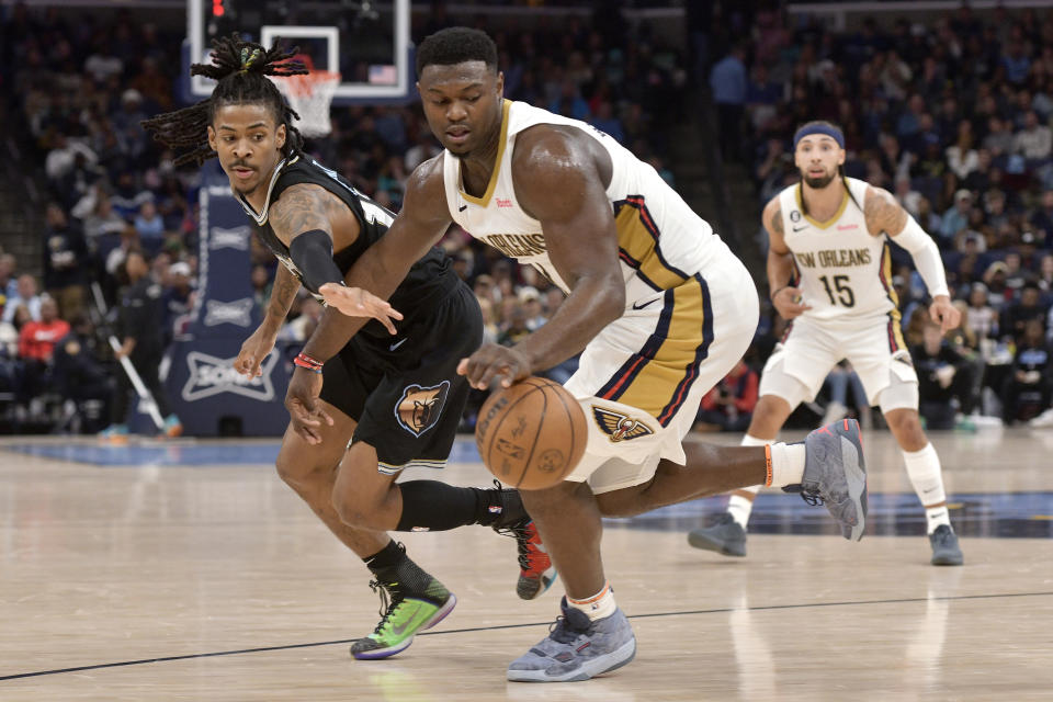 New Orleans Pelicans forward Zion Williamson (1) handles the ball against Memphis Grizzlies guard Ja Morant in the first half of an NBA basketball game Friday, Nov. 25, 2022, in Memphis, Tenn. (AP Photo/Brandon Dill)