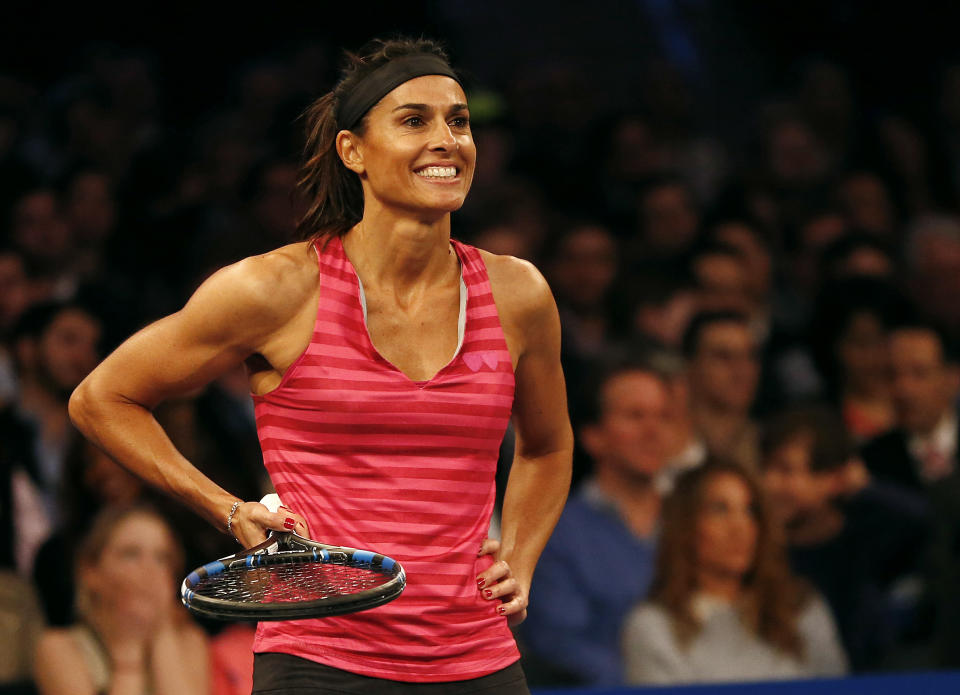 Tennis great Gabriela Sabatini (pictured) smiles during an exhibition tennis match.