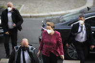 German Chancellor Angela Merkel arrives for a parliament session about a new law to battle the coronavirus pandemic at the parliament Bundestag in Berlin, Germany, Friday, April 16, 2021. (AP Photo/Markus Schreiber)