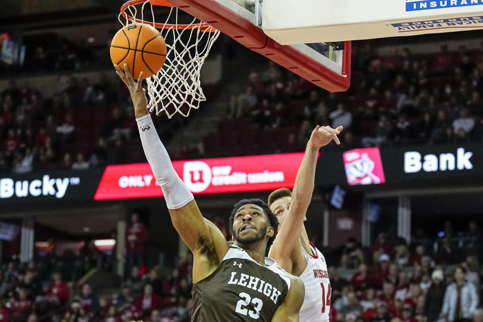 Lehigh's Bube Momah (23) shoots ahead of Wisconsin's Carter Gilmore (14) during the first half of an NCAA college basketball game Thursday, Dec. 15, 2022, in Madison, Wis. (AP Photo/Andy Manis)